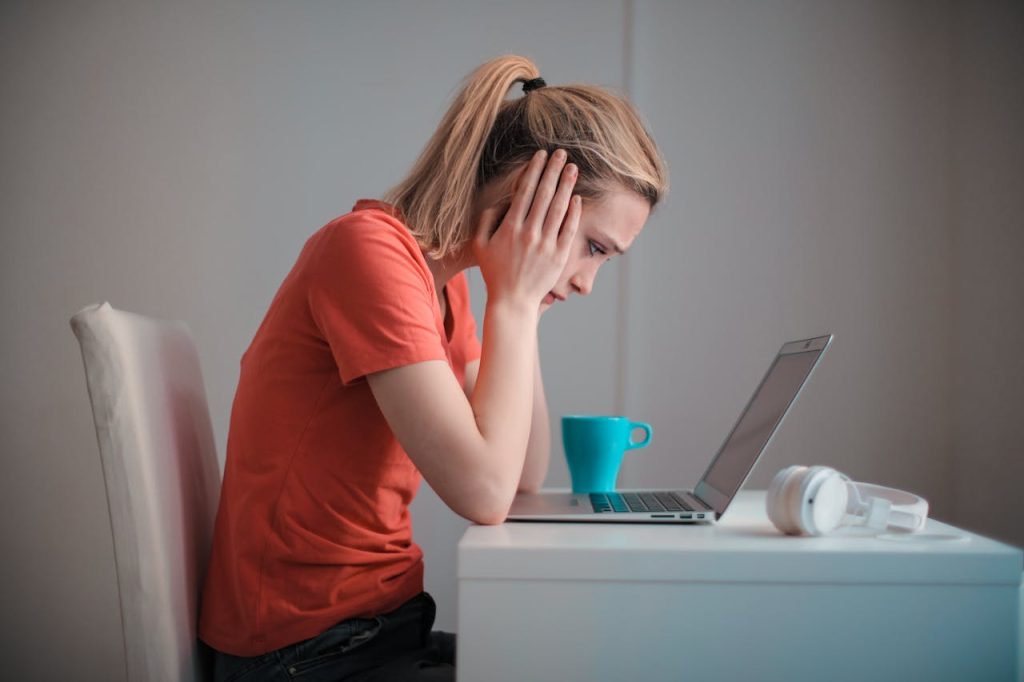 pexels-photo-3755755 Young troubled woman using laptop at home
